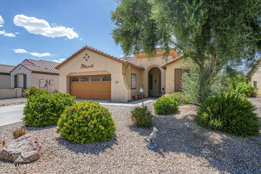 This Riva 1684 model is located in the highly desirable Gated Community of Quail Creek.  The split floor plan offers an Open Kitchen Design with Kitchen Island, Granite Countertops, Lots of Storage and Large Primary Bedroom, and Bathroom.  The Second Bedroom and Bathroom are just the perfect size for guests.  This home also has a Den and features Ceramic tile throughout with carpet in all of the right places. The Screened-In Arizona Room and back yard offer yet again another place to just relax and unwind!  Mature Valencia and Navel Orange Trees will surely provide you with the freshest squeezed orange juice possible.  Many garden beds are ready for the avid gardener, including asparagus plants.