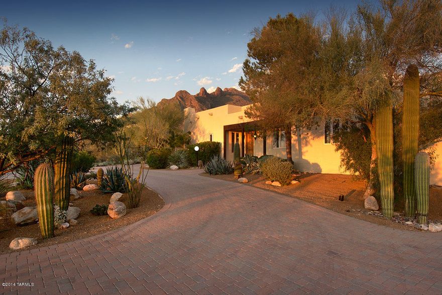 SITUATED IN THE CUSTOM ENCLAVE OF COBO CATALINA HILLS ON A SECLUDED PARCEL JUST WEST OF PIMA CANYON. ENJOY PRIVACY AS YOU BLEND INTO THE DESERT SURROUNDINGS ON THIS LUSH SCENIC 5 ACRE PARCEL. DESIGNED BY ABBOTT HARLE AS HIS PERSONAL RESIDENCE OFFERING LARGE STATELY SPACES, OFFSET WITH AN EASINESS AND FRIENDLY AMBIANCE, INTIMATE COURTYARDS AND WIDE OPEN VIEW CORRIDORS. VIEWS SURROUND YOU AT EVERY TURN WITH LARGE PICTURE WINDOWS CAPTURING MOUNTAIN VIEWS AND CITY LIGHTS BEYOND. A SEPARATE GUEST HOUSE FLANKS THE POOL AREA, WITH A SERIES OF ELEVATED FRENCH DOORS SPILLING OUT ONTO THE GROUNDS. MANY ORIGINAL FINISHES THROUGHOUT WITH MARBLE TILED BATHROOMS, BUILT-INS, HAND-CRAFTED ENTRY DOORS, NATURAL LIGHT WELLS, BEDROOM BALCONIES AND KITCHEN FINISHES, HINTING AT POST MODERN DESIGN.