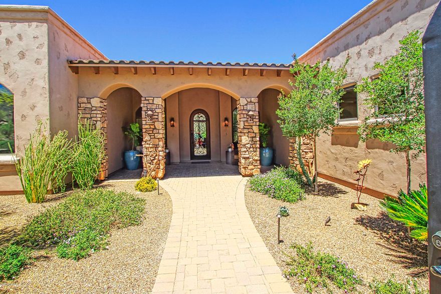 Perched high in the exclusive guard gated Canyon Pass community this gorgeous Tuscan inspired home is loaded with custom upgrades and breathtaking views throughout. Gourmet kitchen is a cooks dream with high-end appliances, beautiful counters and large butler's pantry.  Open to spacious great room with soaring ceilings and fantastic mountain views.  Beautiful travertine tile flooring. Expansive flagstone patio features custom Hayward Omni Logic controlled salt-water pool and spa, upgraded LED lighting, built-in BBQ and firepit overlooking the magnificent canyon.   Luxurious Owner's Suite. Full Media Room (could be 4th bdrm). Oversized 3 car garage w A/C storage area. Some home furnishings available with purchase. This is a stunning home not to be missed!
