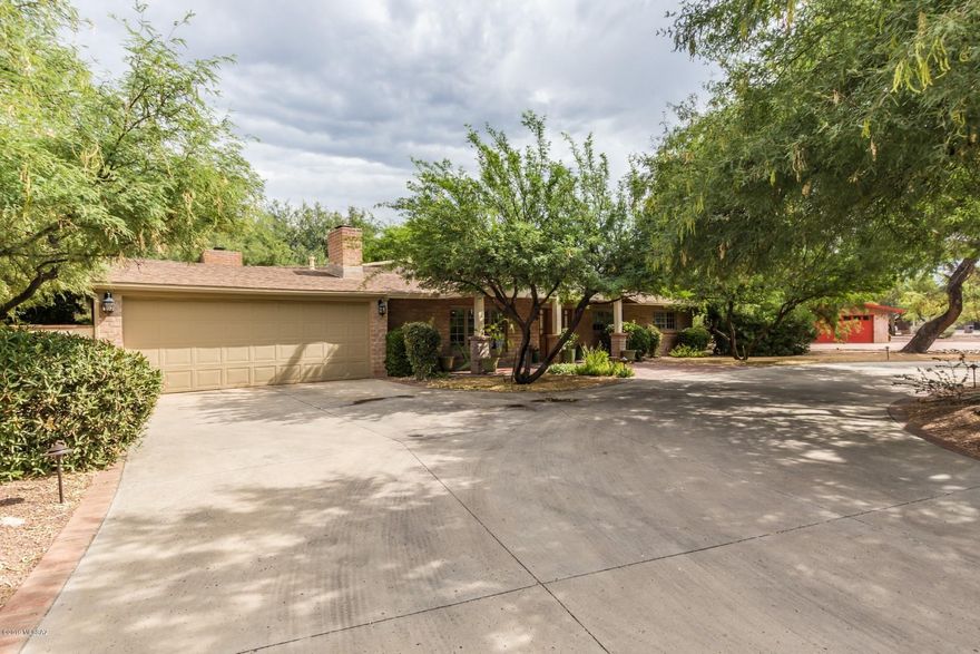 Remodeled to perfection! Luxurious home nestled on a private, lushly landscaped lot in desirable Tucson Country Club. Entertain in this charming 4br + Den home filled with character, wood floors, open floor plan, high ceilings, wood-clad windows. Gourmet kitchen w/ 6-burner gas range, wine cooler, stainless steel appliances, Alder cabinets and granite counters. Inviting master w/ French doors to patio. 4th bedroom guest suite. Spectacular, tranquil yard w/ separate fenced pool/ramada.