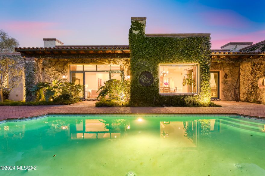 Custom John Klein masonry home sited on a private 1.26 acre lot featuring exceptional craftsmanship & design was the builder's own home. Natural light streams through floor-to-ceiling glass windows & doors that frame the lush landscaping beyond. A striking ivy-covered entry welcomes you to step through the iron & glass front door & discover the visible quality of construction with timeless features of cathedral ceilings, gleaming scored concrete flooring, & exquisite custom light fixtures. The grand living room is anchored by 1 of the 5 fireplaces & wide glass doors lead to expansive brick paver patios. A well-appointed open kitchen includes a breakfast nook & adjoins the comfortably elegant family rm. Split bedrm plan features all ensuite baths w/gorgeous tile work; SEE  'MORE' CONTINUED The romantic primary suite is generously sized & includes a sitting area and charming fireplace, lovely bath & large walk in closet, plus a tucked-away separate patio with a peaceful fountain, & shade portico.  The oversized 3-gar garage is home to abundant built-in in storage cabinets plus bonus storage room and is cooled via a spit-system air conditioning unit. This property has been so immaculately cared for , it can actually be "felt".  A sanctuary away from the hustle of the world, filled with cozy family spaces and room to entertain a crowd, this love-filled home is genuinely special! AND...there is even room to build a guest house or add a sport court!