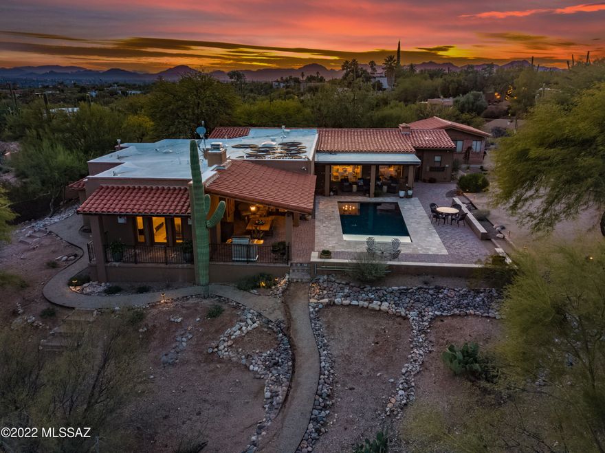 Nestled in the lower Santa Catalinas, one of Tucson's most sought after foothills neighborhoods, Cat 1! Premier shopping and restaurants nearby. Desert living with city amenities within minutes and a great school district.  This stunning home has been exquisitely remodeled and taken from a 2000sf ranch style home to 4295sf featuring 4 brs, 5 ba, living room, dining room, family room that opens to the kitchen and butler's pantry. Dedicated office space with separate entrance. Casita with bathroom is perfect for a more private home office, guest room or gym.  Charming front veranda, porch and courtyard with auto fill fountain. Several outdoor living spaces, recently resurfaced auto fill pool with Cantera stone and paver surround. Newer stained concrete floors throughout, 2 newer Lennox HVAC systems, full alarm system. 2 Wi-Fi irrigation systems, automatic outdoor lighting.  All of this sits on one acre with plenty of parking for your guests and gorgeous mountain views!