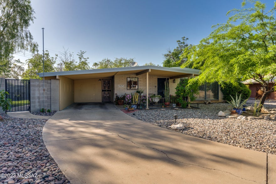Welcome to this beautifully kept 3BR + Den,2 BA home with custom touches. Bonus 520 SqFt Workshop perfect for all your hobbies and projects. The kitchen is a cook's dream with custom Alder cabinets, Granite countertops, and stainless steel appliances. Kitchen cabinets with pull outs including wine rack, making this an efficient space. The Den is a stunning library, complete with plenty of shelves and a seamless connection to the living room. Throughout the home, you'll find new ceramic tile. Beautiful private yard with citrus trees + there's even a rainwater collection system in place. Tons of storage in and out. Come take a look at this gem! Evap cooler & Rainwater system As-is condition (Seller has not used). Chiminea off porch is included as well as compost & wood on table for chiminea.