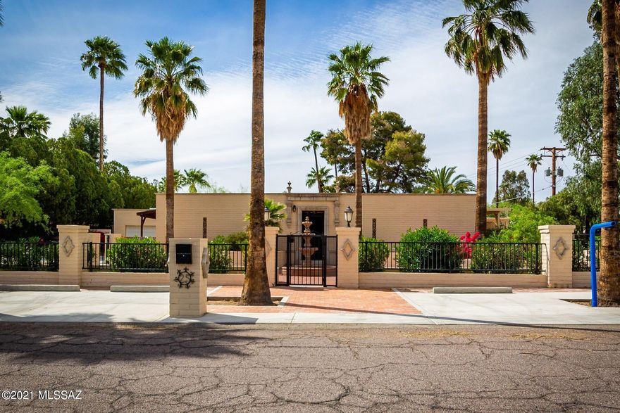 Beautifully unique custom designed home by Arther B. Darton, renowned architect in historic El Encanto Estates. Make a grand entrance in the fenced courtyard with a water fountain and landscaped with palm trees. Come into the foyer to view the enchanted one-of-a-kind glass Atrium in the center of the home. The modern kitchen offers generous cabinets, granite countertops, SS appliances, pantry, and breakfast nook. This home offers 10' ceilings, French doors, skylights, and tile throughout. 5 beds, 6 baths include guest quarters ( 1Br, 1Ba, fam room, & kitchen). Large owner's suite features an oversized walk-in closet , en-suite bath and access to a covered patio overlooking the pool.  Enjoy time in your spacious backyard with friends and family. Make this your dream home.