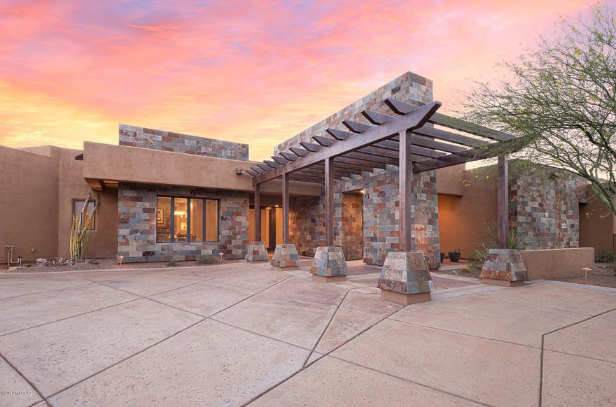 Enjoy perfect blend of luxury & nature in guard gated Stone Canyon Community. 4,209sf 3BR/3½BA+den w/Infinity edge pool/spa, privacy & views backing to open space. Impressive entrance w/distinctive slate wall & iron trellis lead to inviting foyer. Dacor/Sub Zero Stainless appliances, huge island w/hand chiseled granite slab, walk-in pantry, breakfast bar & casual dining area. Family room has slate wall w/gas fireplace w/lighted art niches. Spacious master suite w/slate wall, sitting area, large master bath w/decorative vessel sinks, walk-in shower w/bench, pebble floor & custom roomy closet. Contemporary styling w/Travertine, Pella Glass & Solid wood doors, custom lighted niches & coffered ceilings. Expansive covered patio w/fire pit & outdoor kitchen. 3 car garage w/Tesla charging statio