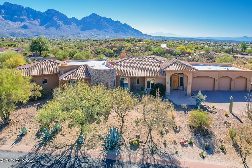 Stunning Catalina Mountain views!!!  Truly beautiful contemporary home 3 bedroom 3 bath plus exercise room and office. Expansive gourmet kitchen with granite counters, center island, stainless steel appliances & wine cooler. Wood beam ceiling in formal dining (currently pool table room) and great room with fireplace. Large master with sitting area and fireplace. Entertainers delight with pool, spa, fire pit and built in BBQ overlooking amazing views. Huge four car garage!