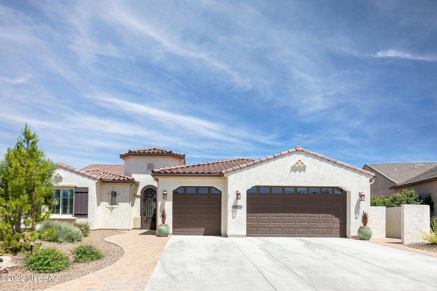 A highly upgraded 2683 sq. ft. expanded Tesoro Model Exterior Design A that has 3-Bedroom En-Suites (Optional Bedroom 3 Suite added); Optional Expanded 3-Car Garage with side door; Expanded Master Suite and Walk-In Closet; and Expanded 2 Suite; and to top it all off a beautiful pool/spa in the back yard w/Solar heating that keeps the pool nice and warm which extends the ability for you to enjoy the pool another 2-3 months! Additional upgrades in the interior of the home include Crown Molding; Wood Floors; Sliding Barn Door on the entry to Master Bathroom; Ceiling Fans, Plantation Shutters; and Upgraded Light Fixtures throughout the home. There is a Built-In Entertainment Center, a Dry-Bar that has both a Wine Rack and refrigerated Wine Cooler in Great Room. The Master Bedroom has Blackout Shades; Back Patio Entry from Master Bedroom; and the Master Bath has a 42" x 60" Jetted Soaking Tub and 42" x 60" Shower and Built-in Seat. The Exterior of the home is professionally landscaped both front & back. Sellers added a custom-made Security Door leading into the front entry. The back yard has a large 220 sq. ft covered patio with an attached Pergola giving you ample shade during the day; a gas Fire Wall; Flat Screen TV, and again, an incredible Pool and Spa. Optional Rain Gutter surround the home. The Optional Extended 3-Car garage also includes the Overhead "Gorilla" Storage Racks, Utility Sink, Water Softener System, and owners replaced the water heater for a larger 75-gallon capacity. There are additional cabinets in the Owner's Entry, Laundry Room, and Butler's Pantry which has been configured into a working office. If you are looking for a true 3-Bedroom Ensuite home with almost every optional extension possible and then a beautiful pool and spa in the back yard with an extremely large, covered patio making it the perfect entertainer's back yard, this is the home for you! FULL FIRE PREVENTION SYSTEM.