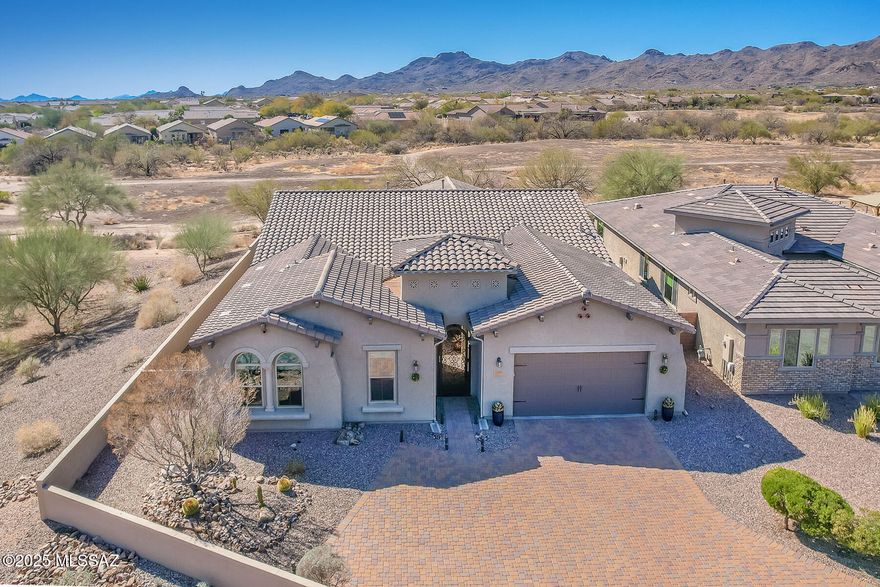 Stunning, highly upgraded 4BR/3BA (3,081 SqFt) gated home at Center Pointe Vistoso offers Catalina & Tortolita views & backs to the Vistoso Trails Nature Preserve for privacy. Brick paver drive/courtyard flow to large gathering room w/ porcelain plank tile & 10' ceilings. Gourmet kitchen w/breakfast bar & nook affords countless amenities. Enjoy a formal dining room, den/office + media room. Split bedroom plan hosts an extended Owner's Suite w/luxury bath & huge walk-in closet. Also featured are tray ceilings, plantation shutters, ceiling speakers & extended 3-car tandem garage. Travertine tile highlights the rear covered patio & yard w/BBQ station, firepit, hot tub, turf area, citrus trees plus block & view fence. Center Pointe offers a clubhouse, pool/spa/splashpad & playground
