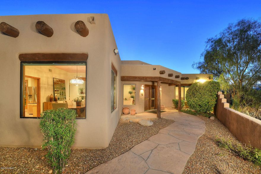 This excellent 5 bedroom (or 4 BR plus office) Southwestern contemporary is high on a hill in Skyline Bel Air Estates and offers sweeping Catalina Mountain views. Highlights of the 3,552 sq. ft. residence include a welcoming foyer with art niches & viga beams, an open flowing floor plan, a spacious living room with a fireplace, a family room with a fireplace & walls of glass, high ceilings, expansive windows, neutral ceramic tile & carpet flooring, and a 3-car garage. The generous gourmet island kitchen provides Corian countertops, alder cabinetry, a breakfast bar & area, and stainless steel appliances. The gracious master suite offers 2 walk-in closets, a garden tub and dual vanities. Enjoy the wonderful walled-in yard featuring an expansive covered porch, a pool/spa and panoramic views!