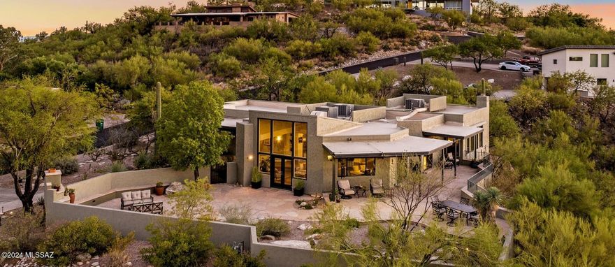 When a native Tucsonan says ''Wow'', you should take note!  You simply won't find a better view of Finger Rock from anywhere in town unless you hike to the top! This gorgeous Foothills home is perfect in so many ways for so many reasons- #1- Totally renovated, reimagined & redesigned by a CA Architect from tip to toe for both luxury living & the ''lock and leave'' lifestyle. #2- Sought After Gated ''Foothills II'' community at the base of the Catalina's with Finger Rock trailhead right outside the gate & only 4 min to AJ's & La Encantada! #3- Ideal open floorplan w/ dramatic mountain & stunning city views from large windows in every room & a thoughtfully designed guest wing, complete with 2 bedrooms, a full bathroom and a TV room / den type space. #4- Interior Designer touches throughout earthy warm colors and luxurious quality finishes that are timeless in design including the all-new white kitchen w/stainless appliances and beautiful granite slab counters & backsplash. #5- The primary bedroom is a spacious retreat, with fireplace, floor to ceiling windows for enjoying incredible sunset & city light views, luxurious spa bathroom and walk in closet. #6- A Fab corner lot adorned with exotic cacti and beautiful desert plantings all hand selected for a beautiful, lush landscape with low maintenance care in mind & NO pool! The expansive new flagstone patio features a gas fireplace, elevated dining area and banco seating for you & your closest 100 friends. Furthermore, this home would be ideal for anyone looking to downsize but not downgrade in style or for a seasonal residence to escape the cold winters without the threat of hurricanes, tornadoes or earthquakes. This home truly is the epitome of the perfect Tucson Lifestyle. From the custom designed steel front door to the new wood-look porcelain tile throughout, the spa-like bathrooms to the gourmet kitchen, the high ceilings to the multiple entertaining spaces & patios, this home will not disappoint. Surrounded by larger multi-million dollar homes, this home presents a unique opportunity to live in this exclusive enclave & should not be missed!  This meticulously remodeled & well-maintained home is ready for you to move right in & for the "right price", the sellers will consider selling it furnished! Please see the list of improvements for all the details.