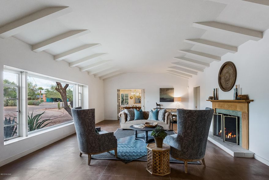 This exceptionally preserved residence in Historic Catalina Vista is a treasure of local architecture and enduring style.  Polished concrete floors, handmade doors with vintage hardware, coved ceilings, and 4 fireplaces.  The formal living room with beamed ceiling opens to a large dining room.  A butler's kitchen adjoins to an extraordinary full kitchen with St. Charles cabinets and stainless steel counters.  The centerpiece of the home is an Arthur Brown designed ballroom featuring Terrazzo floors with brass inlay and 14 foot ceilings, ideal for entertaining. The walled backyard contains a sparkling 1940's Hollywood starlet pool.  The attached guest quarters with 2 bedrooms, living room and kitchen has a separate entrance. Just steps from the Arizona Inn and University, this elegant specimen of local history is perfect for an architecture enthusiast.