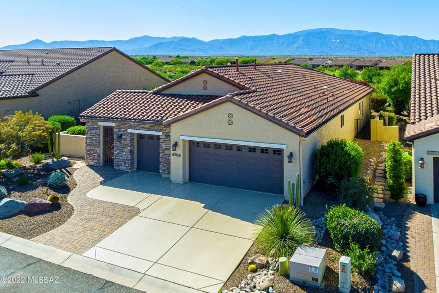 Panoramic mountain views, privacy, & a spacious interior await in this rare gem. Relax on the generous covered patio with beautiful view of Mt Lemmon or enjoy the sunset over the Tortalitas from the rear patio w/ motorized screens.  A private front courtyard can be accessed directly from the guest room featuring a wall bed system & credenza, making it dual purpose for guest room, an office, a fitness room, or a casita. Kitchen has generous L-shaped island w/2 pantries and roll out shelves, & 3''' crown molding. 2018 frig & range. Formal dining room for entertaining, or can be flex space for other interests. Large laundry w/full cabinets, storage on both sides. Many upgrades. 2x6 framing. All this plus the amenities of a resort community. Within walking distance of fitness center.