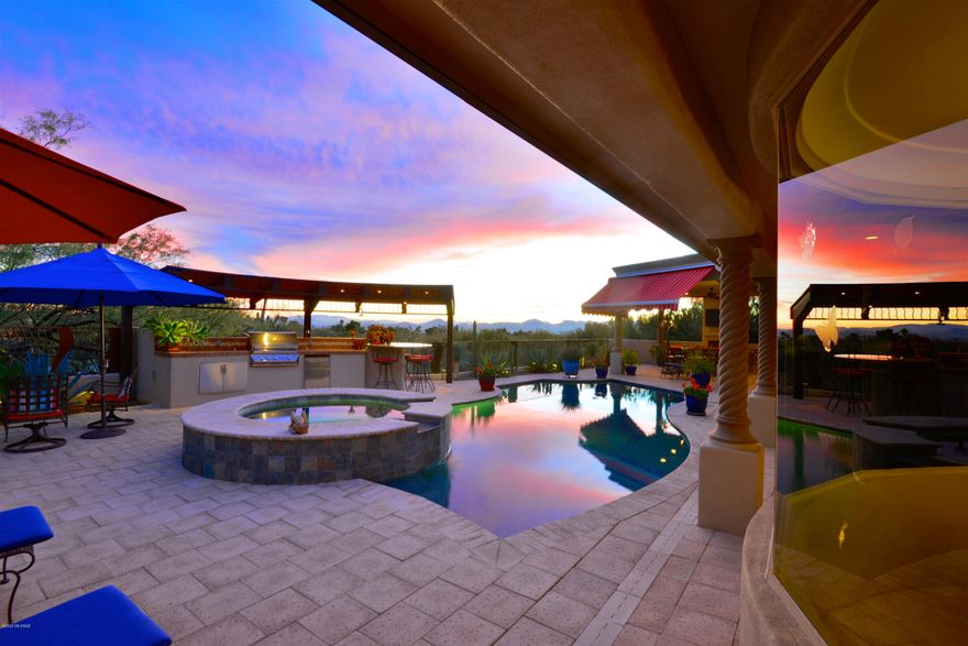 Stunning hilltop home on 1.5 acres in Skyline Country Club. Almost seamless transitions from the magnificent patios, city & mountain views to the updated interior. Views from every window and door. The Catalina Mts are breathtaking and the city lights twinkle above one of the most incredible pool, spa, outdoor kitchen and living area in Tucson! Completely updated over the last few years, this incredible home includes 4 bedrooms, 3 fireplaces, gorgeous open family and living rooms, floor to ceiling windows, professional low care landscaping and more. Forever views. Elegant yet inviting. Perfect for entertaining yet extraordinarily private.