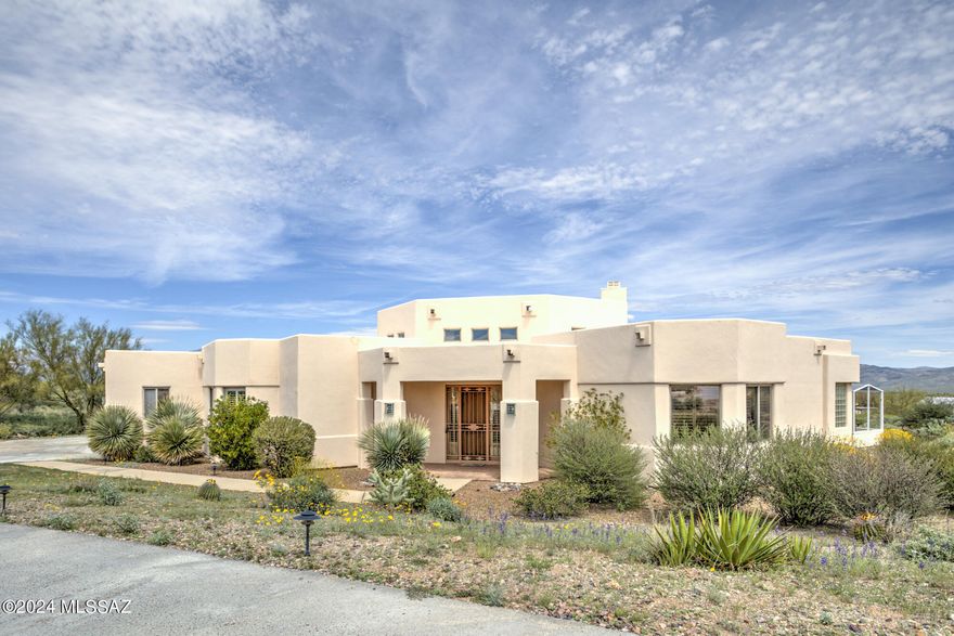 Located on the east side of Tucson, this beautiful home sits on 3.3 acre with full majestic views of the Mountains! With 3,050 square foot of living space, it has no interior steps, 4 spacious bedrooms, 3 full bath, and a 3 car garage. Step inside the front door and you can see the Catalina Mountains right across the living area through the windows. The large living area has high ceilings with gas fireplace as the center piece that connects with the kitchen for an open concept. All windows have custom shutters to let light in or stay out. The spacious kitchen has lots of counterspace, tons of cabinet for storage, dual ovens, a nice size center island, a walk in pantry, and breakfast area. With a split floorplan, it has 2 bedrooms on each side of the house. The primary bedroom is bright and airy with many windows for views, dual vanities, a soaking tub, shower, and large walk in closet. Step outside to your backyard patio and enjoy the privacy and mountain views! Close to Saguaro National Park East, bike paths and many walking trails. COME SEE IT TODAY!!