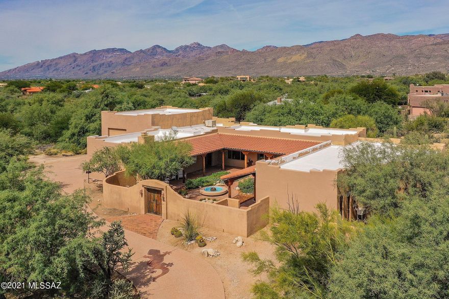 Beautiful hacienda style with courtyard entry. Custom built one owner Bells & whistles galore. Gourmet kitchen with custom oversized, soft close, Alder cabinets, granite counters & backsplash, GE Profile appliances & a huge island with seating. Four bedrooms, (seller used largest one as a media room), & three bathrooms means room for all.  An oversized RV garage with attached workshop plus a 2 car garage with storage, just to knock your socks off. Room for a half court basketball, ( already lined out) billiards or ping-pong etc. If you can dream it you can put it in this garage. Then there is the art studio, another WOW! Plumbed & ready for your custom work. Power already in place for hot tub in area outside of art studio.
