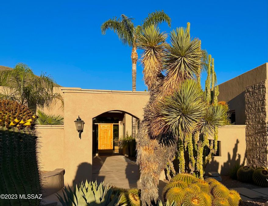 Outstanding 4 BR & 4 BA desert contemporary located in the coveted guard gated community of Ventana Canyon. A charming courtyard entry w/fountain, cactus,& palm trees leads to this well maintained home featuring an open & split floor plan with the primary suite and bonus room (theater/den/library) on one side, and three guest rooms & bath, including one en-suite on the other side. Fine features include travertine flooring, large picture windows, formal living & dining rooms, and a beautiful island kitchen with breakfast bar and eating area all opening into the great room w/ FP. Exceptional outdoor living areas including one oversized covered patio w/FP and outdoor kitchen, and another elevated open patio w/ FP. Lush palm trees & cactus line the putting green, pool & spa w/mountain views.
