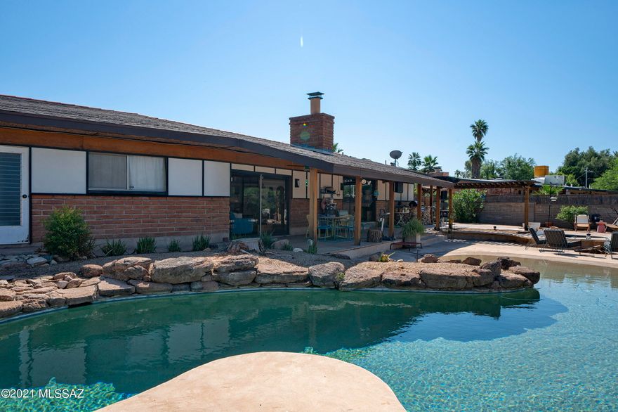 Seller will accept or counter  offers between $500,000 and $530,000. Built, in 1963, .53 acre lot, 2647 sq ft Mid Century home has a beach entry pool, spa, and is an entertainers delight. 4 Bedroom 2.5 Bath. Private foyer entry with shoji screens.  Kitchen has stainless steel appliances. Formal dining room with reclaimed chalk board floors, bamboo wall paper and original mirrored accent wall.  Step down into a sunkin living room or open the wall of shoji screens to create open living spaces.  Recently added cork flooring, wonderful built ins, ample storage and great closet space. Smart home technology.  Outdoor living with pool, spa, firepit, built in BBQ and wonderful covered porch.  10 X 14' BOMB shelter with fresh air intake fan. Backs to wash for privacy. RV hook up MUST SEE!