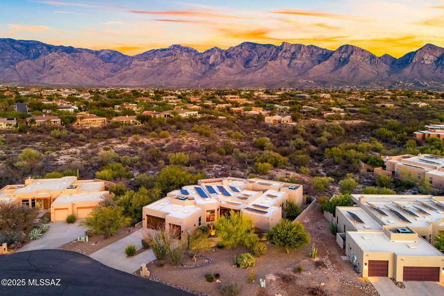 This Luxurious Custom Santa Fe retreat is the true epitome of Sonoran Desert Living.  It is the embodiment of refined elegance and exceptional luxury.  It offers unobstructed views of the majestic Pusch Ridge Mountains, dazzling sunrises and sunsets, and the shimmering city lights.  The glorious sunsets bounce off the mountains creating a visual masterpiece, captivating the eyes and the soul. Situated on the best lot in the subdivision, a premium private cul-de-sac lot, on just under an acre, and backs onto over 10 acres of open space, this estate is a haven for wildlife viewing.  
Nestled in the highly esteemed Vistoso Estates, this unique Oro Valley residence beckons at every turn! The gated front courtyard adorned with a tranquil art deco fountain, provides a serene entrance, replete with flourishing landscaping that envelopes the property in verdant splendor, and an ambiance of resort-like seclusion!   The commanding front door opens to a breathtaking foyer and into the expansive open concept great room. As you step inside, you are immediately captivated by the impeccable views and the welcoming sense of home.   
Indoors, every detail is curated to captivate and impress. The open floor plan and soaring viga beam and wood ceilings create an airy and spacious ambiance, reflecting the owner's pride in this exquisite property.  Picture windows elegantly frame the breathtaking mountain views, inviting the splendor of the outdoors into the living space.   All the furniture and furnishings were carefully selected to enhance each space (they can be purchased by a separate Bill of Sale).  At the heart of the home lies a tranquil atrium spa oasis enhanced by a soothing waterfall, a true paradise.
This entertainer's delight features a floor plan designed for the quintessential Arizona lifestyle, both inside and out. Open and spacious living areas present a charming beehive fireplace, alongside a well-appointed kitchen that will delight any culinary enthusiast. Kitchen highlights include an expansive center island, exquisite granite counters, a substantial island, luxury stainless and black appliances, Knotty Alder cabinets, wet bar, walk-in pantry with a 60-bottle wine refrigerator, and a separate double-door closet pantry further enhance the culinary experience.  Featuring four spacious bedrooms and three and a half bathrooms, one of which has a private bath, entrance and patio, making it a unique and inviting guest retreat. 
The luxurious primary suite offers a sanctuary of relaxation, and features gorgeous Brazilian Teak wood flooring, a separate home office, a vast custom walk-in closet, and a lavish bath with an expansive, tiled shower and a true soaking tub.   
Create unforgettable memories in the luxurious backyard oasis, meticulously designed for both entertainment and relaxation. Delight in a refreshing dip in the heated pool with a cascading waterfall, perfect for year-round enjoyment, complete with a mesmerizing waterfall feature. This entertainer's paradise boasts a beautifully epoxied expansive patio, walkways, and pool courtyard, complemented by two distinct entertaining areas adorned with beehive fireplaces, and an outdoor kitchen, ideal for alfresco dining under the stars and basking in the magnificent sunsets.  Elevate your evenings by ascending to the rooftop deck for stargazing and witnessing the city lights illuminate the night sky.
Crafted with exceptional precision by Canada Vista Homes, the esteemed subdivider and builder of this luxurious enclave, this residence stands as a testament to unparalleled craftsmanship. Originally conceived as the builder's personal abode, this home boasts extraordinary custom features including viga and wood beam ceilings, stately 8-foot Alder wood doors, and exquisite tumbled marble and stone tile flooring in the main living areas. The home office and primary suite are adorned with opulent Brazilian Teak Wood flooring, adding a touch of exotic elegance. Additionally, the property is equipped with whole-house HEPA filtration and a myriad of energy-efficient features to ensure the utmost comfort and sustainability.  Indulge in the luxury of owned solar, which remarkably reduces electric bills to a mere $26.37 per month.
This estate exemplifies the pinnacle of luxury and enduring quality.  With all these exceptional features, this home embodies the essence of an Arizona gem waiting to be discovered. Minutes from world-class amenities, shopping, dining, golf, tennis, pickleball, a dog park, is conveniently adjacent to a bicycle and walking path, ensuring you enjoy the best of Tucson living, Oro Valley Hospital, hiking, the renowned Hohokam Park, Oro Valley Community Center, Library, Riverfront Park, and the Steam Pump Farmer's Market Oro Valley offers the best of Tucson living.
This signature residence perfectly blends distinct pride of ownership with elevated luxury living. This incredible opportunity awaits - welcome home!
