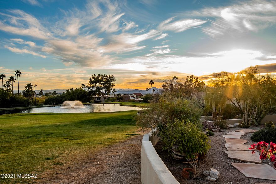MAGNIFICENT MOUNTAIN VIEWS and GOLF LOVER'S DREAM right on the 7th hole of gated Skyline Country Club, overlooking the peaceful pond! FABULOUS, COMPLETELY REMODELED 3 bedroom MASONRY home with a CONTEMPORARY flair! Chef's kitchen with granite countertops, stainless appliances, amazing gas stove, beverage refrigerator & island with breakfast bar. Lovely, warm bamboo wood & neutral ceramic tile floors. Beehive fireplace with granite surround. Nicely remodeled bathrooms, all new windows & doors. Huge master closet & all closets w/ excellent built-ins. Expansive covered patio w/ built-in BBQ, to use while enjoying the LUSH greens and serene setting. Low care yard to just sit and relax...Truly the MOST PERFECT spot in all of Tucson! IMMACULATE! PHENOMENAL VIEWS & LOCATION! Can't be beat! HURRY!