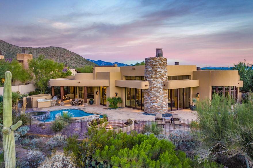 Former model at Gated Ritz-Carlton Residences at Dove Mountain in Tortolita Mountain foothills just minutes to downtown Tucson. Enjoy a lifestyle that is fascinating & delightful utilizing Ritz hotel & spa amenities, clubhouse, golf, Olympic-size pool, hiking, biking & walking trails.4,836sf 4BR/4½BA home + 574sf 1BR/1BA guest casita. Private courtyard w/water feature & fireplace. Impressive custom metal pivot entry door to great room w/soaring tongue & grove ceilings & fireplace strategically placed between two collapsing disappearing window walls. Natural stone/hardwood floors, granite counters, Sub Zero/Wolf appliances, home automation & wine room. Each BR is ensuite w/private bath. Pebble tec pool/spa, fire pit & outdoor kitchen w/golf course, mountain & sunset views. 3 car garage.