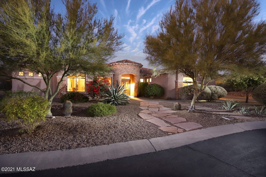 Elegant contemporary home located in popular Dos Lagos at Dove Mountain.  Enjoy Tortolita mountain views as you walk in through the big picture windows in the living room.  Spacious & open floorplan features huge kitchen that opens to living & great room. Outdoor living at its best includes pool, spa, firepit, built-in bbq, putting green and big covered patio. Kitchen features granite, island, double ovens, huge pantry and breakfast bar seating plus breakfast nook.  Big owner's suite features views, patio access, 2 big walk-in closets and luxurious bathroom with garden tub & separate shower.  Den/office provides custom built-ins.  Split bedroom plan features two spacious guest bedrooms, both with ensuite private bathrooms. 3 car garage & huge laundry with storage space.