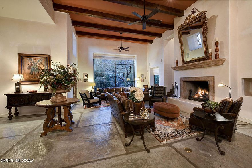 A timeless Spanish Colonial Masterpiece with unmatched city and mountain views.
Located on a quiet cul-de-sac near the top of Alvernon way and nestled in the coveted Catalina Foothills, this meticulously crafted 4-bedroom, 4-bathroom home spans 4,025 square feet of luxurious living space on an expansive 0.88-acre lot. 
With sweeping Catalina Mtn, Finger Rock and Tucson city views, every detail has been thoughtfully updated, masterfully blending timeless Spanish Colonial charm with contemporary sophistication.  Enter through a grand front courtyard, complete with a tranquil fountain, and pass through the impressive 11' historic mesquite hacienda door, imported from Mexico. Inside, you'll be welcomed by a magnificent great room featuring soaring 16' ceilings, a ornate wrought iron chandelier, beautiful faux stone flooring, and handmade steel windows & doors. The walls are adorned with refined imperial plaster, creating an ambiance of warmth and elegance.  This home has undergone a stunning transformation, with significant upgrades throughout. The chef's kitchen, fully redesigned in 2022, boasts top-tier finishes and modern appliances, while the bathrooms have all been completely remodeled. The laundry room has also been updated for added convenience. The luxurious primary suite, remodeled in 2022, offers a serene retreat with Venetian plaster walls in the bedroom and a custom California Closet.  Rustic Manganese Saltillo tile, installed throughout the bedrooms, primary bathroom, and closet, adds a touch of natural elegance that complements the home's overall aesthetic.  Step outside to enjoy the exceptional Tucson weather in your expansive backyard. The outdoor space includes a sports court, lush artificial grass (2021), two oversized concrete vegetable garden planters, and a brand-new BBQ (2022), perfect for entertaining and outdoor cooking. The pool area has also been updated with a new pool pump (2020) and sand filter (2021), ensuring a pristine swimming experience year-round.  This home features a range of updates for optimal comfort and convenience, including a tankless water heater (2019) on the east side, new AC/furnace units (2018) on the east side, and newly installed water heaters (2024) and AC/furnace units (2024) on the west side. A central vacuum system (2023) enhances daily living with ease.  Located in the prestigious Catalina Foothills, this home offers unmatched proximity to top-rated schools, shopping, dining, and all that Tucson has to offer. With its expansive lot, exceptional updates, and flawless attention to detail,  this residence stands as a true masterpiece.