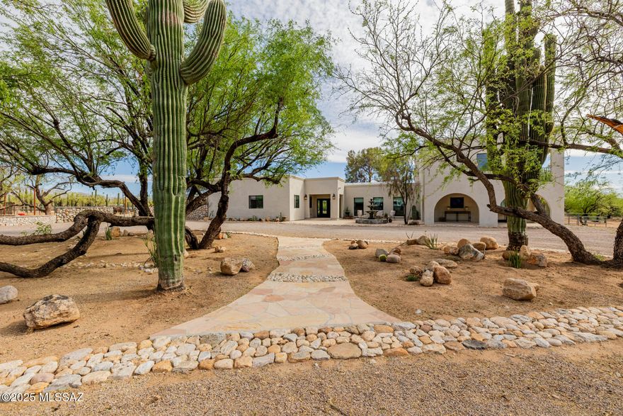 Luxurious 10-Acre Equestrian Estate with Mountain Views, Seasonal Stream & Trail Access

Discover a rare opportunity to own an exquisite 10-acre equestrian estate where nature's beauty and refined living come together in perfect harmony. With sweeping mountain views, direct trail access, and a seasonal stream that gently flows through the property, this one-of-a-kind retreat offers an unparalleled lifestyle of serenity and sophistication.

Upon arrival, a paved and covered patio welcomes you with an elegant fountain, setting the stage for the grandeur within. Enter through custom wrought iron double doors into an immaculate interior, featuring luxury flooring, exposed wood-beamed ceilings, and ambient recessed lighting throughout. Perfect for entertaining, the sunken living room and formal dining area each boast their own classic wood-burning fireplace, creating warm, inviting spaces for gatherings. The gourmet kitchen is a culinary dreamcomplete with an oversized quartz island with breakfast bar, premium stainless steel appliances, an abundance of white cabinetry, a custom tile backsplash, and a spacious walk-in pantry.

Retreat to the lavish primary suite, where a cozy fireplace, French doors to the patio, a private balcony, a spa-inspired ensuite bath, in-suite laundry, and a charming loft offer the ultimate escape.

Outdoors, nature lovers and equestrians alike will be enchanted by over 180 majestic saguaros, countless mature mesquite trees, and direct access to scenic trails for riding, hiking, or exploring under the desert sky.

This estate is more than a homeit's a private sanctuary designed for those who crave luxury, space, and the unparalleled beauty of the Sonoran landscape.