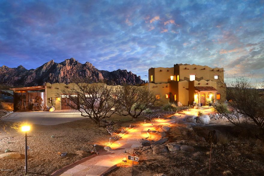 La Casa de los Peñascos (The House of the Boulders). Custom, organically designed, 4B/4B Santa Fe/Craftsman home and casita, set in a garden of granite boulders. 40 acres of high desert, bordering the beautiful Coronado National Forest. Open your eyes each morning to breathtaking views of the Dragoon Mountains. Luxurious and livable open floor plan. Granite, unique tilework, custom cabinetry and detailed touches, with quality materials throughout, in an impeccably maintained home. Private second-floor Master Suite, with office. Set in Dragoon Mountain Ranch, a gated, horse friendly community, with sensible CC&Rs to protect your investment. Heaven for those who love open space and captivating views, to ride horses, walk dogs, and explore the unique beauty of the historic Cochise Stronghold MLS Description of 8060 E. Diamondback Road (additional description)


This exceptional home is located in the picturesque mesquite grasslands of the Chiricahua desert, at a cooler 4800 feet of elevation, with sweeping views of five mountain ranges. Every detail of this nearly 4000 square foot home was carefully chosen by the current owners. Dominating the Great Room is a gigantic natural granite boulder, half inside and half outside the home. The Great Room also features a wood-burning, kiva-style, Rumford fireplace and viga log ceiling. The Mexican and Arts & Crafts tile work, straight-grain Douglas fir interior doors and trim work, and quarter-sawn oak cabinetry, show a Craftsman influence throughout. Ascend the one-of-a-kind Arts & Crafts staircase to your private Master Suite, where you can watch the local wildlife visiting your own backyard watering hole, and enjoy the magnificent close-up views of the Dragoon Mountains. Enjoy a large private his and hers office, with copper counters and unlimited storage, not to mention the gorgeous views while you work from home. This residence also features high-speed fiber optic internet service. 

Enter this property through a beautiful custom-gated entry, which showcases the local wildlife and plants. Twenty acres, of the forty acres, are already fenced. Should you wish to add a barn or other additional structure, power and water are already available. There are spacious covered porches for enjoying outdoor living. An enormous walled, boulder-studded, professionally landscaped, lighted and irrigated courtyard, with covered swimming pool, provides a secure area for pets and children. The pool includes an in-floor cleaning system, electric cover and solar heating system, with gas already piped to the pool equipment, if future year-round pool heating is desired. There are also irrigated garden tanks for growing your own veggies. A hot tub is nestled in next to gigantic sheltering boulders and surrounded by trees. Imagine yourself soaking in warm water under dark star-studded skies, with unequaled quiet and a feeling of complete peace. 

This home features highly energy-efficient construction, with strong 14" thick, R-49 Rastra block walls. Rastra is a well-tested type of insulated concrete form (ICF) that does not burn and is impervious to termites, rodents and mold, plus it is made from 85% recycled materials (Rastra.com). There is also a grid-tied photovoltaic (PV) solar system with micro-inverters, and internet monitoring of power production and system health. This is a Net Zero home which produces more electricity than the current owners pull from the grid. 

This home uses energy-efficient Lennox forced air furnaces and air conditioners, with three heating/cooling zones. There are also whole house fans in the main house and casita, to reduce summer cooling costs. The water heater is also large and highly efficient, with a rapid recharge rate, for when you have a house full of friends and family visiting. 

There is a spacious 2 Â½ car garage, with plenty of room for work benches and extra storage. In addition, there is a custom-gated RV port with full hookups. 

This home features a separate 1B/1B guest casita which uses the same high-quality materials and finishes as the main house, and includes a fireplace and large covered porches. All appliances, and everything one needs for comfortable long-term living, are included. This casita is a perfect and complete small home for family or friends. 

Enjoy the gated privacy and sensible CC&Rs of Dragoon Mountain Ranch. The opportunities, from your doorstep, for horseback riding, dog walking, hiking, star gazing and exploring the granite boulder maze of the Cochise Stronghold and the Coronado National Forest are unlimited. Winters are mild and sunny. The peace and quiet here in the high desert of Cochise County are second to none. Good healthcare, grocery stores, an 18-hole championship golf course, and much more, are available nearby. It is only an hour plus drive to Tucson International Airport, and all the amenities of Tucson. This one-of-a-kind home, in its distinctive setting, will be an extraordinary place for you to live and enjoy life to the fullest. 

                                  Features List:
- 3070 sq.' Main House with 3 bedrooms and 3 bathrooms
- 888 sq.' Guest Casita with one bedroom and 1 bathroom, fully self-contained
- 36.87 acres with beautiful Custom Solar Gated Entry, and 20 Acres Fenced
- Bordering on the Coronado National Forest and the West Cochise Stronghold
- Closest views of spectacular Dragoon Mountains on Dragoon Mountain Ranch
- Enormous granite boulders scattered inside and outside the home and property
- 100% contractor built, with full county inspections of the quality construction
Indoor Living:
- Open Concept Great Room for Living/Dining/Kitchen, with gigantic indoor boulder
- Large Rumford Kiva Fireplace in Great Room, wood-burning
(all the Mesquite firewood you will ever need can be cut on the property)
- Enormous Kitchen Island with red Viking Gas Range
- Granite countertops; double-basin fire clay Farmer sink from England
- Pantry with Custom Storage System and Second Freezer
- Custom Cabinetry throughout the home; Cherry, Hickory, Quarter-sawn Oak
- Beautiful custom Arts & Crafts staircase with Motawi Sacred Datura tiles
- Straight grain, Douglas Fir interior doors and hand-picked door and window trim
- Extensive custom Arts & Crafts and Mexican tilework throughout the home
- Private Master Suite on second floor, with spectacular views and roof access
- Master Bath with dual vanities, granite counters, TV, private toilet room with view
- Private Dedicated His & Hers Office with copper counters and unlimited storage
- Oversized Master Closet with Custom Closet System
- Laundry Chute from Master Bath to storage cabinet in Dedicated Laundry Room
- Separated Main Floor Guest Area; all Handicapped Accessible
- Custom Hall Library, with storage cabinets
Outdoor Living:
- Swimming Pool with walkable Automatic Safety Pool Cover, In-Floor Cleaning System, Pebble Tec surface, and Solar Heater (and Prepped for Gas Heating)
- Enormous Walled Courtyard, Professionally Landscaped, Irrigated and Lighted
- Beautiful boulder and tree setting for your hot tub, under the stars
- Expansive Covered Porches, fully tiled and lighted
- Highest quality, easy care, Synthetic Grass Lawn Area
- Irrigated Garden Tanks for growing veggies
- Natural Boulder Outdoor Fire Pit Area
- Easy access to hiking, climbing or horseback riding; wonderful star gazing
 
Energy Efficiency:
- Net Zero Home with a Grid-Tied 10-kW Photovoltaic Microinverter Solar System, with internet monitoring of energy production and system health
- Constructed with 14" thick R49 Rastra insulated concrete form walls
- Low-E, energy efficient windows with no-maintenance aluminum cladding
- Energy-efficient Lennox forced air heating and air conditioning
- Triple-Zoned heating and cooling system in main house
- Extra energy-efficient water heater in main house; tankless water heater in casita
- Whole house fans in main house and casita; ceiling fans throughout
- Sola-Tubes in entry and master closet
- New energy-efficient, variable-speed programmable pool pump installed in 2014
Guest Casita
- Designed for comfortable long-term living, with all appliances including laundry
- Built to the same standards as the main house
- Wood-burning fireplace; granite countertops
- Large covered porch with electric wind/sun screens
- 3-way-switched, lighted pathway between casita and main house
Utilities:
- Private Well with 1500-gallon storage tank and freeze-protected booster pump, electronically controlled.
- Underground power and telephone; satellite television
- Propane tank
- High-Speed Fiber Optic Internet to main home and casita
- Individual septic systems for main house and casita
- ADT security system
Other Features
- 2 1â„2 Car Garage with workshop area, extra storage and painted floor
- Covered and custom-gated RV/Car Port with electric, water and septic hookups
- Flagstone and boulder front entrance pathway, with 3-way-switched lighting
- High-quality roofing and stucco systems
- All porches covered with custom clay roofing tile
- New roof system installed on main house in 2014
- New roof installed on casita in 2013
- Main home and casita fully painted and stained in 2015
- New, low-maintenance, energy-efficient garage doors installed in 2017
*Buyer(s) to verify information here that might be a material fact to them*
