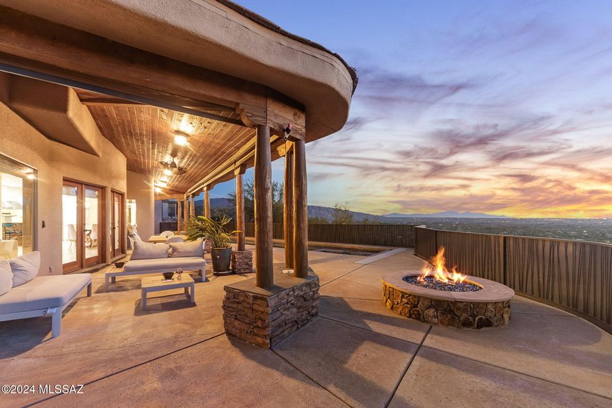 Welcome to a masterpiece of luxury living nestled into breathtaking Catalina Mountain landscape. Remarkable 3+ acre estate combines modern elegance with natural beauty,
offering unparalleled living experience that seamlessly blend the two. As you approach the grand entrance, a stunning custom knotty alder front door invites you in- framed by majestic
granite & flagstone, alongside a multi-tiered fountain & lush landscaping. Step inside to experience soaring 20+ foot cathedral ceilings leading you into a truly grand living space. Great room, with its dramatic stone and wood entry, is bathed in natural light from a wall of windows & French doors, offering panoramic views while
enjoying luxury within. Gourmet kitchen features exquisite agate & mesquite countertops, dual Viking...SEE MORE dishwashers, separate freezer & refrigerator, a Viking 6-burner range with griddle & char grill & a massive walk-in pantry with a dumbwaiter. V- shaped island has a prep sink & storage, coupled with a stainless farmhouse sink boasting a hot & cold on - demand filtered water systems.
Continuing on the tour in this lovely 5-bedroom, 5 full bath home is the primary suite. Situated on the mezzanine level, the room promises ultimate luxury, with hardwood floors, stone-faced walls with fireplace, a walk-in closet & a spacious ensuite bath featuring dual vanities, a steam shower & a soaking tub with 180-degree views. Two sets of doors lead to dual private balconies, making it a tranquil retreat.
Across the catwalk, find another room- this one a loft style bedroom with walk-in closet & full attached bath. Downstairs, another full suite with large ensuite bath and fireplace, can be used as a luxury office or for generational living.
On the top floor are two more spacious bedrooms with a Jack and Jill bath, built in dual desk space & its own den. Additional features include large laundry room off garage with dumbwaiter down to ground floor pantry, oversized 3 car garage, and a floor plan flexible enough for any needs! The lovely separate casita has one large room with kitchen plus full bath & large closet.
Transitioning outdoors, the property boasts a 50-foot lap pool w/ spa & a poolside full bathroom. The backyard includes over 1600 square feet of covered space, perfect for enjoying the jaw-dropping city views. The multi-tiered meditation & sculpture garden, lush with vegetation & fruit trees, offers serene views of the surrounding mountain ranges. Multiple water features encompass the property completing the feel of total privacy. 360-degree views, outdoor kitchen, multiple water features, a gas fire pit with lava rocks, UV- protected flagstone pathways- this property truly has it all. Whether enjoying the city views from the backyard porch or relaxing in the hidden shaded room off the front porch, this home is a sanctuary of luxury & tranquility, perfect for making timeless memories. Tanque Verde schools. Close to recreation, shopping, restaurants & Mt Lemmon.