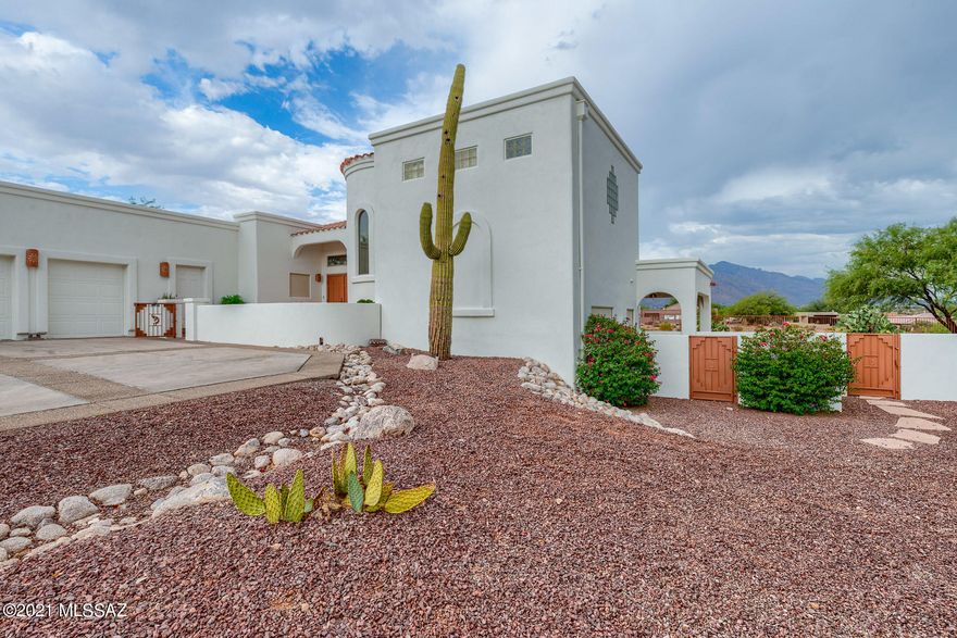 Gorgeous VIEWS of the Omni Tucson National Golf Course and Catalina Mountains. Lovely custom split-level home with east facing backyard patios for afternoon shade and heated pool. Main floor has living room with gas fireplace, sit-up wet bar area, kitchen, dining room with built-in buffet and china cabinet, huge utility room, office, extra office or craft area and half bath. Upstairs is a large master suite, private patio with fabulous views and large bath area with two walk-in closets. Downstairs is a bedroom, full bathroom and a game/rec room with sink.  Oversized two-car garage and cart garage plus large storage room. Home is loaded with storage and flexible spaces.  Game/rec room could be made into third bedroom.  Don't miss your chance to own this one-of-a-kind home in great location.