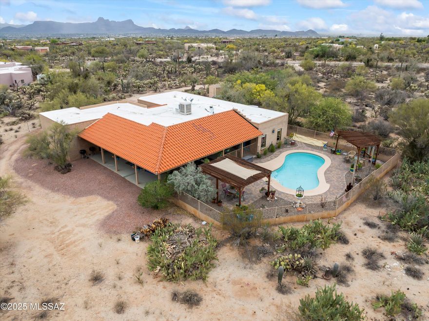 No HOA! Mountain views. Poolside serenity. The Arizona dream awaits. Set on 3.72 acres of peaceful desert beauty, this meticulously maintained slump block home features a split floor plan w/ a private ensuite perfect for guests w/private pool access and Saltillo tile that is  truly gorgeous!  Enjoy the newly replastered pool, wrap around patio, breathtaking Catalina & Tortolita mountain views, and unforgettable sunsets! Outdoor living areas invite entertaining, stargazing, and quiet moments in nature. A hot tub slab w/ hookups is ready for your personal spa experience. Recent upgrades include newer HVAC and water heater for worry-free comfort. Plenty of room for corrals, gardens, RV Parking. Tucked back from the road, you'll feel worlds away yet you're just minutes from ''town! See ''more Just minutes from shopping, dining, and entertainment in Oro Valley and Marana including the Premier Outlet Mall, Dove Mountain, The Ritz Carlton and a plethora of golf courses and dining options. Don't miss this rare chance to live the Arizona lifestyle with freedom, privacy, and unbeatable views.