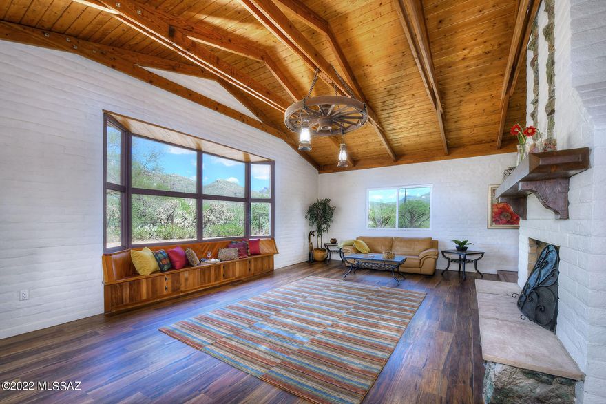 Stunning remodel combining old and new in this Tanque Verde Home. Located on almost 4 acres near the base of the Catalina Mountains, it offers a very special retreat.  Step into the living room featuring a ceiling with raised hand-built trusses, custom decking, stone fireplace & wonderful mountain views. An open kitchen with large walk-in pantry, includes an eating area, and a separate dining area.  The bedroom wing includes 4 bedrooms, 4 baths, laundry and an extra room for workout or storage.  An additional bedroom is off the Arizona room with a separate entrance and mini split.  A guest house is also located on the property and offers potential to make it your own. A second parcel adjacent to property is included in the sale. New HVAC.