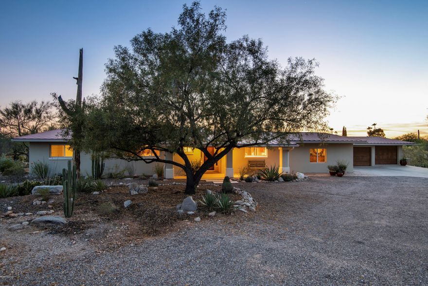 **Please see Virtual Video Tour located in Photos Tab and at https://player.vimeo.com/video/419669223** Understated exterior of this Southwest Contemporary belies a high ceiling and immensely open interior where the great room, den and kitchen share panoramic mountain, desert, and sunset views by day and city lights by night, and where the covered patio beckons. Nestled on an acre in the rolling contours of highly desirable Catalina Foothills Estates No. 7, the home, patio, pool, and casita are so secluded by native vegetation that it's hard to believe you're only minutes from excellent shopping and dining, the university and downtown Tucson. Kitchen features generous cabinetry, granite counters, stainless appliances (including Dacor range) and pantry. Travertine unifies open living. Two master suites with exceptional closets, plus an additional ensuite bedroom with patio access. Casita with Murphy bed offers fifth bedroom suite.(View from casita is spectacular!) Two fireplaces. Three-car garage. Sustainable efficiencies include zoned AC, owned solar array that powers both home and an electric vehicle (garage port), and xeriscape fed by passive rainwater harvesting and laundry water recapture.