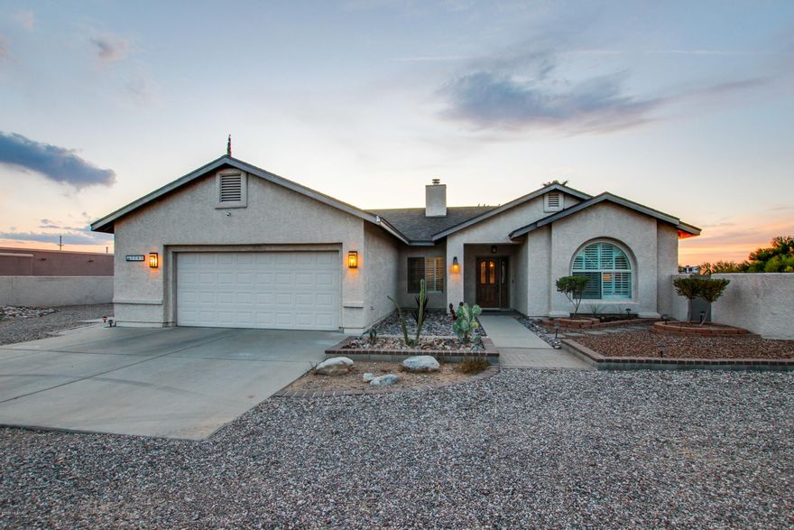 Gorgeous 4 bedroom 2 full bathroom home sitting on 1.5 acres of land with FULL RV HOOKUPS! A must see property with breath taking views of Arizona's beautiful sunsets. This home has an impeccable backyard layout with lovely views made to entertain guests or relax alone in your backyard oasis. Ceramic tile throughout the house. This charming home has a HUGE 2 car garage with plenty of cabinets and storage space, walk in closet in the master bedroom and a double vanity in the master bathroom. Located in the kitchen you will find stainless steel appliances, double sink, island, dishwasher and tons of cabinet & counter space! A cozy wood burning fire place in the living room and a great deal of space to decorate it and make it your own. Swimming spa & fountains do not convey.