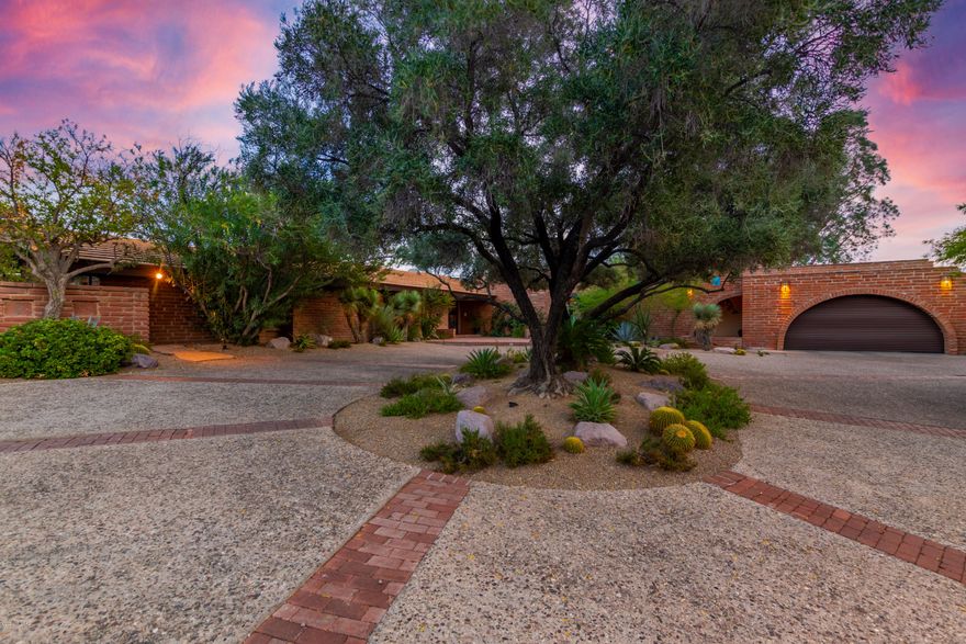One of a kind, architecturally designed home. This expansive 6 bedroom, 6 bathroom home offers 5,813 Sq Ft of unique features and gorgeous architecture. Built in 1958 and designed by Nicholas Sakellar. Enter into the teak floor foyer that opens up into the massive great room with support beams delivered from Oregon, hidden motorized bar and two sliding glass doors to bring the outside in. Full length glass pocket door in the formal dining area that leads out on to the back patio with stunning city views. Kitchen has been updated with bamboo floors and custom cherry cabinets by Tom Klijian. 2 car garage off kitchen with access to an air conditioned workshop with additional washer and dryer hookups. 2 beautiful sunrooms with horizontal solar screened windows, one of which has Occupied Japan tiles from 1945. The second sunroom/office, master bedroom and bathroom were added onto the home keeping the integrity of the original design. The master bathroom was updated in 2011. It is equipped with a giant tub, shower, dual vanity and heated floors for extra comfort. The lower level of this home includes a laundry room, bathroom, two guest bedrooms, and a breeze way leading to a second 2 car garage.  This home has incredible mountain and city views with lots of land and privacy.