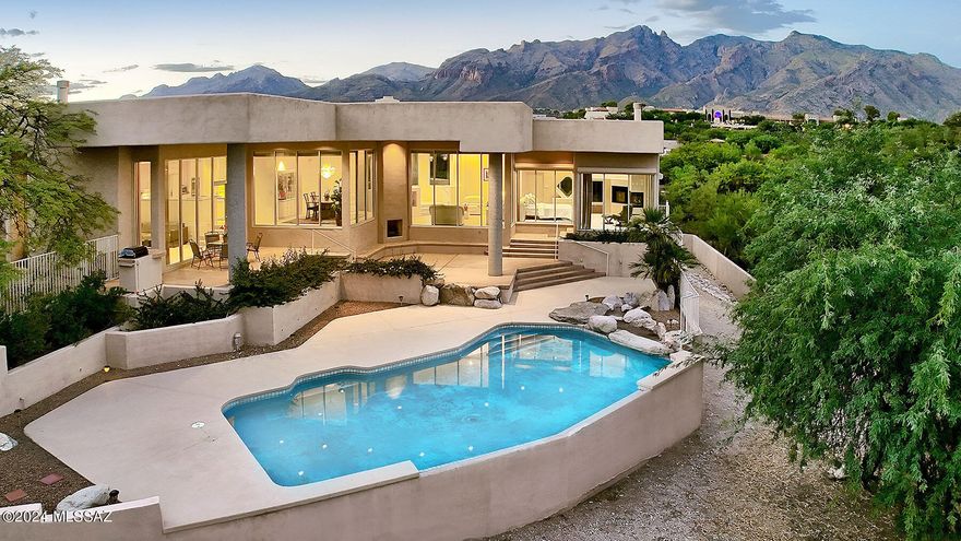 Stunning contemporary w/city & mtn. views in Catalina Foothills Est #3. Private motorized gates, courtyard entry, exquisite living rm w/15 ft. high ceilings, floor to ceiling windows, formal dining rm w/chandelier, large gourmet island kitchen w/granite countertops, gas stove top, dbl. ovens, 2 dishwashers, Sub Zero, prep sink, breakfast bar & lovely breakfast area, desk, pantry, beautiful tile floors, family rm w/fireplace, 4 bedrooms & 3.5 baths in main house (3608 sq.ft) including primary bedroom w/fireplace, sitting area, walls of windows, lux. bath w/marble countertops & floors, dbl vanities, Jacuzzi tub, separate shower & very large walk in closet & laundry rm + guest house w/bath(730 sq.ft.). Fabulous bkyd w/ covered patio, pool, landscaping, 4 car garage, Dist. 16 schools & views!