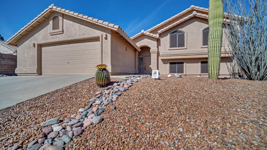 Nestled in desirable Oro Valley, indulge in sophisticated southwest living in this meticulously-maintained five bedroom, three bath home boasting high ceilings and broad windows with magnificent views. This 2,440 square foot split-level floor plan is ideal for entertaining with a roaring great room fireplace and arched door entry into the bright formal dining area. The eat-in kitchen offers plenty of storage with ample cabinetry, large pantry. Laundry room includes front load washer & dryer. Relax in the spacious master suite featuring a walk-in closet,  en-suite- bath with executive height vanity, dual sinks, walk in shower and lovely jetted tub. Enjoy a fully-appointed home theater with Panasonic projectors, 142'' fixed projection screen, surround sound, 3D technology Enjoy beautiful mountain views from your covered and uncovered patio areas.  This incredible home offers southwest serenity at its , finest.  Original owner has meticulously maintained this home, you will not be disappointed.