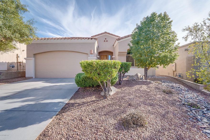Spectacular 4 bedroom, 2 bath 1825 Sq ft home with mountain and golf course views. Tile flooring in all common areas, security system, ceiling fans, window coverings, fireplace plus upgraded cabinets throughout and cultured granite in bathrooms. Bright eat in kitchen with granite, stainless appliances, gas range, tile backsplash and pantry. Master suite has beautiful wood laminate floors, private bath with split dual vanities, garden tub and walk in closet.  Enjoy your low care back yard with patio, extended pavers, beehive fireplace and built in BBQ. Located in the Award Winning Vail School District. Easy access to shopping, I-10, Raytheon and DM.