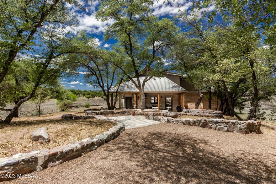 Escape to the finest in country living!  Stunning rammed earth home in the 200 acre tree-studded Casas Arroyo de Sonoita. Scenic views from every window of this 3198 sq ft, tri-level home. Fully renovated in 2020-2021 with loads of high end amenities.  Patios off the kitchen, dining room, and family room. Primary bedroom & bath is on the main level with its own private balcony. Downstairs features a large Family Room wi/pellet stove, Office, & storage. Upstairs are 2 bedrooms, full bath, a  Game Room & large Storage closet.  Huge garage with plenty of room for workshop & hobbies.   On  a large .57 acre lot in the midst of 200 shared acres with trails, a community pool and water company. Please see the attached list of features for a better understanding of everything this home has to offer