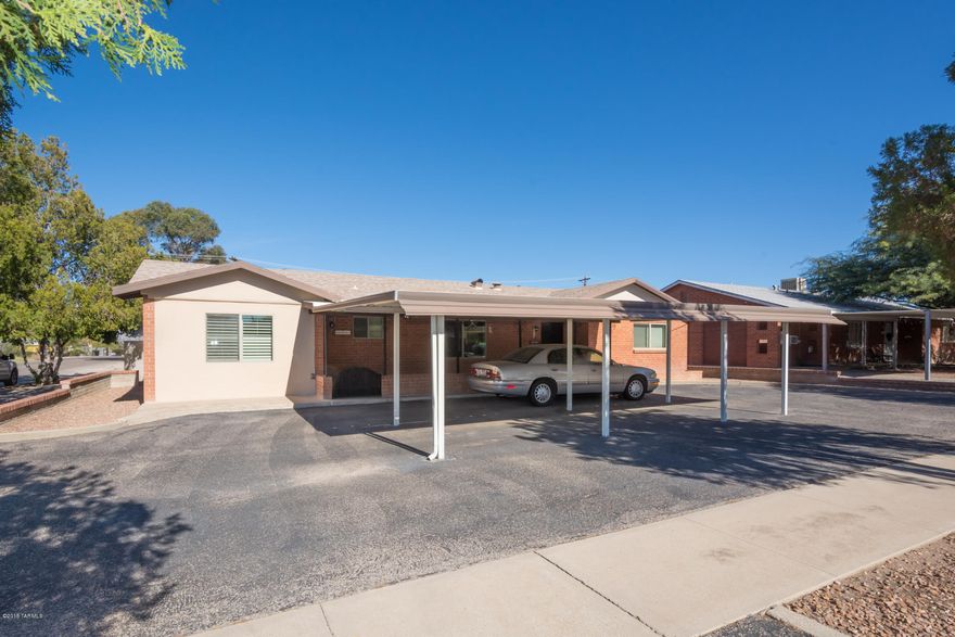 This lovely 1950’s “1 owner” charmer has been meticulously maintained, is located on a terrific corner lot & has something for everybody. Fabulous block walled-in backyard with large covered patio, lots of hardscape, grassy area, & built-in BBQ/firepit, perfect for entertaining. The car buff will be delighted with the double gated entry to the carport in the backyard with attached workshop & storage, not to mention the very large 2-car carport that fits closer to 4 cars.  Inside you will appreciate knotty pine cabinets, tile backsplashes, laminate flooring, dual pane windows with shutters, game room & ceiling fans throughout. All will appreciate the newer 19-seer A/C unit, hot water heater & upgraded electrical panel. Great central location convenient to shopping & dining. Come see t