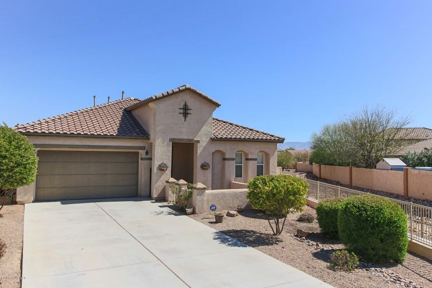 Remarkable home!! This home features a long list of home owners desires!! Features include a long driveway, side of home borders common area, stunning wood looking tile floors, and shutters throughout the home. Kitchen features include granite counter-tops, double ovens and new stove-top plus spacious center island. This 3BR, Den, 2BA, 2483 sq. ft. house is a show stopper with it's very popular floor-plan and nicely appointed upgrades. Spacious backyard and 2 car garage with cabinets and peg board for additional storage. Don't miss this home in the Award Winning Community of Rancho Sahuarita!!!