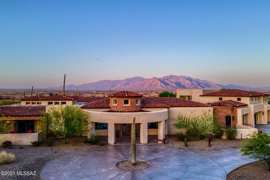 Welcome Home to this Gorgeous, Hidden Desert Oasis on 3.31 Acres in Northwest Tucson.  7113 sq. feet, 6 Bd, 6 Ba, 4 Car Garage, Theater & Negative Edge Pool. Step into the Custom front door leading you to the expansive living Room w/ Wet Bar & Wine Fridge and Formal Dining Room, right around the corner from the Gourmet Chefs Kitchen, Oversized Island and Top of the line Bosch Appliances.   
The main house boasts 4 Bd, 4 Ba, custom Home Theater Room.  Master Suite Features Dual Fireplace, Gorgeous En-Suite, Dual Sinks, Walk-In Shower, Separate Walk In Closets w/Access to Laundry Room. 2nd Master Suite & 2 Add Bedrooms. Separate Guest House, 2 Bd, 1 full bath. Great room open to Dining Room & Kitchen. Outdoor Oasis with Multiple Covered Patios Living Space Extends to a enjoy the Catalina Mountain View's, Negative Edge Pool, Space for Bar, Pool Bathroom, and Endless Saguaros and Desert Landscaping. Priceless Views, Stunning Sunrises &  Sunsets, Live Everyday at your Private Resort.