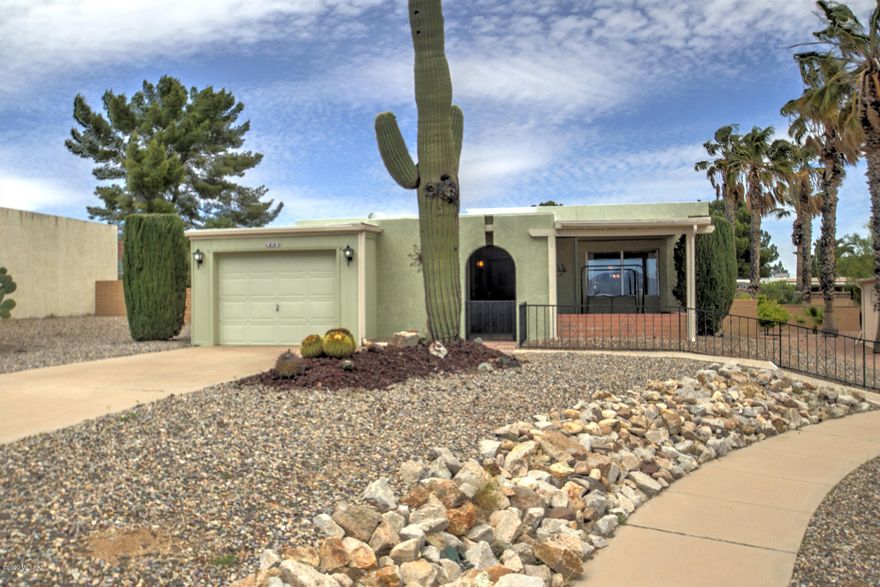 This well-maintained home is move-in ready. Terrific mountain view from the front porch and living room. The traditional kitchen keeps cooking activities separate and you'll find plenty of cabinetry and a pantry closet. Relax in the spacious AZ room and enjoy back-yard privacy with a territorial block perimeter and desert landscaping. Furnishings and fully equipped kitchen included. The garage is large enough for a suburban with separate storage area. This community offers its residents a swimming pool, hot tub, pickleball courts, tennis court, shuffleboard, pool table, artist studio with kiln, kitchen, grill, and a library. GVR is also available if interested.