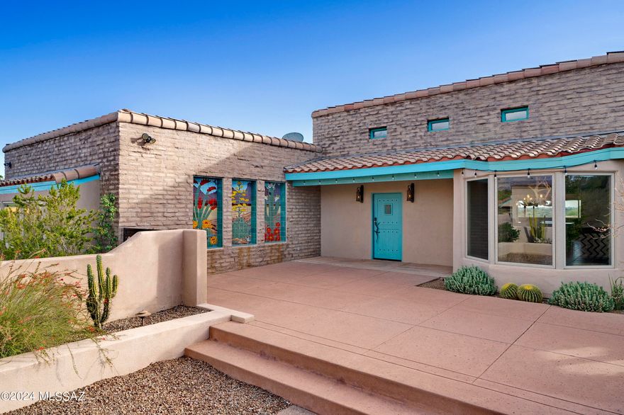 This special courtyard adobe hacienda sits on 3 acres in a small cul de sac near Swan/River and offers panoramic views from its elevated lot.  Dramatic 13' ceilings in the main room for living, dining and kitchen  -great entertaining space - featuring skylights and wood ceilings.  Split bedrooms with large primary suite and beautiful en suite with pedestal tub.  Covered patio facing south for views of 3 mountain ranges, U/A and downtown.  Custom details throughout.