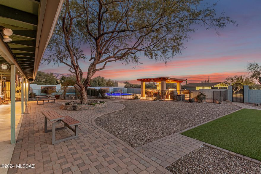 Explore 3.65 acres of horse property with RV 50/30/20 amp hook up in this stunningly remodeled 4 bed, 2.5 bath home. Revel in the beauty of wood plank tile throughout the home and studio. The chef's kitchen features quartz countertops, stainless steel appliances, and a spacious island with a butcher block top. Abundant storage and an oversized laundry room add practicality. The backyard is an entertainer's dream with a Pebble Tec finished pool, owned pool solar, rock water feature, outdoor kitchen ramada, turf, garden beds, 1500 gal water cistern and ample space for enjoying both sunrise and sunset mountain views. The detached 407 sq ft airconditioned and heated building offers versatility for a home business, office, classroom, convert to a tack room or creative pursuits.
