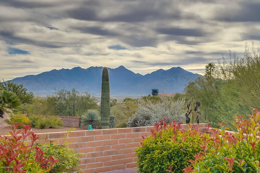 YOU CAN HAVE IT ALL! It starts with the entry onto beautiful travertine floors. The kitchen has been updated with quartz counter tops, soft close and pull out cherry cabinets plus stainless appliances. Enjoy the ''park like'' back patio with mountain views, privacy with arroyo behind, and waterfalls. Other features include 2-way fireplace, glass block showers, large walk-in ''california design'' closet, laundry sink, water softener, wood shutters, updated lighting, and the list goes on...