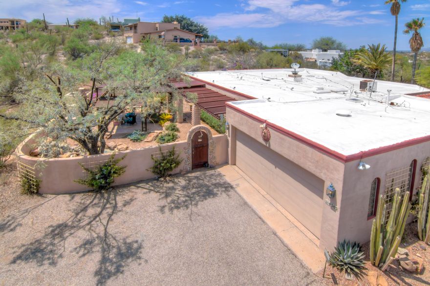 Own your private Shangri-La on over an acre of lush desert nestled within custom iron fencing with gates that welcome you home. This luxury home is an entertainers dream with amazing artistic flair. Begin your tour in a welcoming courtyard and to the quiet sounds of water, as you approach the outdoor patio and fireplace, tastefully covered by an iron pergola and full-length covered patio and porch. Inside you will find an upscale gourmet kitchen including maple cabinets, tasteful slab granite, high-end appliances, opening to an off-kitchen living area, with fireplace and beautiful hardwood oak flooring. Step outside to enjoy the grand pool-side oasis with multiple patios and multi-sided fireplace, gourmet outdoor kitchen, majestic views and breathtaking sunsets. See Matterport Tour Today!