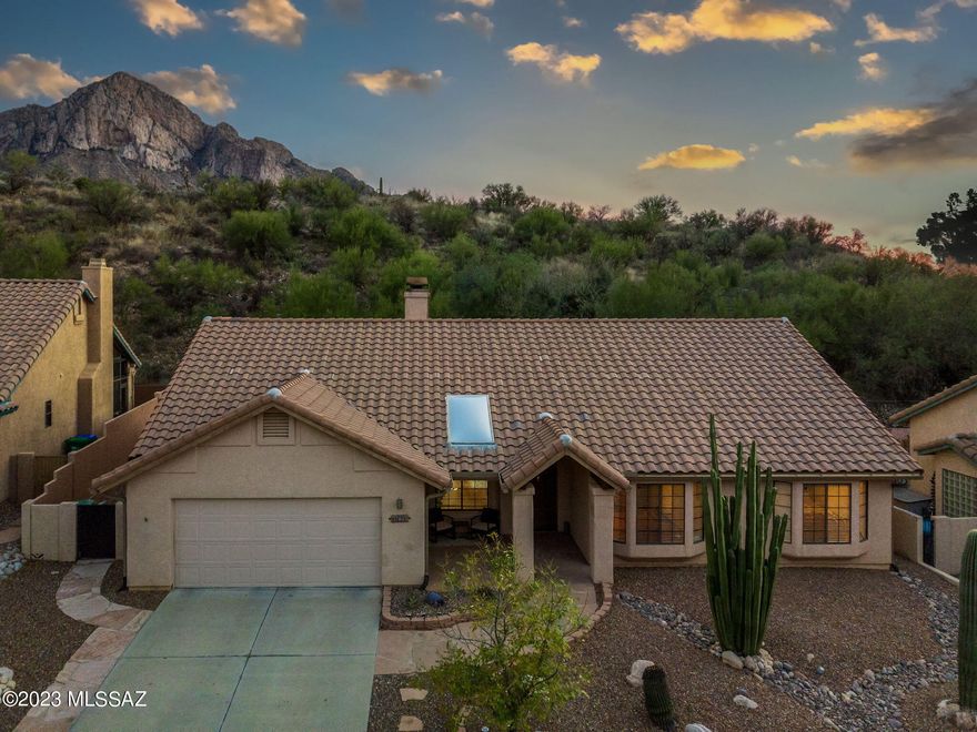 Welcome to La Reserve, a gated community in the heart of Oro Valley! This stunning 3 bedroom home is nothing short of impressive, featuring a bright and spacious floor-plan with soaring high ceilings, and plenty of natural light. Enjoy cozy nights in front of the 2-way wood burning fireplace in the living area, or entertain in the formal dining area, breakfast nook, or breakfast bar. The kitchen is a chef's delight, boasting upgraded cabinets, plus a huge pantry/prep space to store all your cooking supplies. The inviting light wood look floors bring a warm and inviting atmosphere to the home. The master suite provides a tranquil escape, complete with an updated master bath. Current owners have made many upgrades in the past year, including a Bosch Variable Heat Pump, a smart hot water heater,  overhead outdoor commercial heater, fenced backyard, granite countertops, quartz sink, and induction cooktop. Experience luxury living at its finest with this beautiful home!