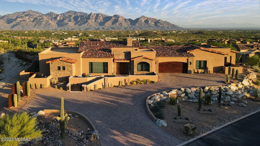 An exceptional Marc Soloway designed residence in Tucson's Stone Canyon Club, the premier, private, guard-gated golf community in So. Arizona. Featuring elevated, non-obstructed, fully protected, 360-degree views of the Catalina mountains, Tucson city lights, and Tortolita mountains. 3907 sq ft interior living space finished with the finest choices. Featured in Luxe lnteriors and Design Arizona Spring '23 magazine for First-Place ASID award-winning residential outdoor living space design (Deluxe Designs of Arizona.) Built in 2020 and in immaculate like-new condition. 12-foot ceilings, over-sized Italian porcelain flooring throughout with luxurious Fabrica carpet in the bedrooms. See the attached Features & Description PDF for the extensive list of amenities or contact agent for more info. Features and Detailed Description - 14572 N. Shaded Stone Place

This is one of the exceptional pieces of property in Tucson's Stone Canyon Club, with elevated, non-obstructed, fully protected, 360-degree views to the Santa Catalina mountains, downtown Tucson, the Tortolita mountains, and more. The home perches on top of a hill in a quiet neighborhood within the larger community.

Stone Canyon Club is the premier, private, 24-hour guard-gated golf community in southern Arizona and sits in the foothills of the Tortolita Mountains in Oro Valley, Arizona. It offers the Jay Moorish Signature Design championship golf course, a luxurious health and fitness facility, a gourmet restaurant and bar, as well as leagues, clubs, and amenities for all ages.

Designed by prominent Arizona architect Marc Soloway, this beautiful home offers:

Just over 3,900 square feet of interior living and more than 2,000 square feet of exterior living, everything finished with the finest choices.

The primary living spaces have the highly desired eastern exposure, with breathtaking views of the Santa Catalina Mountain range, downtown Tucson and many of Tucson's surrounding mountain ranges.

The property is adjacent to 33 acres of conservancy land, protecting the entire northern exposure from future development.

The home is three years new, with very light occupancy.

The home was featured in Luxe lnteriors and Design Arizona Spring '23 magazine for First-Place ASID award-winning residential outdoor living space design (Deluxe Designs of Arizona)

lnterior highlights:

Living areas feature 12-foot ceiling heights with Western Windows sliding doors and windows to take in gorgeous views. All doors and windows are custom-tinted and have powered Hunter-Douglas custom coverings. ln addition, nearly every window has a Tucson Rolling Shutter mechanized solar screen on the exterior for additional sun protection.

The home offers a beautifully designed, well-appointed gourmet kitchen with inset-style maple cabinetry finished with cast brass hardware from Top Knobs artisan collection. A cook's kitchen, the home has some of Wolf's latest appliances, a Sub-Zero refrigerator / freezer, a Bosch dishwasher, and a custom-designed pantry with over 300 linear feet of storage. The center of the kitchen is a gorgeous K-2 granite waterfall island with plenty of seating. The striking backsplash is designed and hand made at Tabarka of Scottsdale.

Adjacent to the kitchen is a dining room with a stunning Los Angelas artisan Cisco Pinedo salon-glass canopy pendant light, a wall of windows overlooking the Tortolita mountains, and a 10-foot-long wet bar with a Sub-Zero wine refrigerator, U-Line beverage center, Fisher-Paykel dishwasher, and a prep sink with garbage disposal.  Above the K-2 granite countertop is another custom-designed, hand-painted backsplash by Tabarka.

The great room features a fabulous Montigo Distinction fireplace with multi-color LED uplighting, ceramic glass and a driftwood log insert. The fireplace and cool wall are accented on both sides by glass display shelves and hand-hewn wood parquet accent walls by Tabarka.

Flooring throughout the home is an over-sized, easy-to-maintain, neutral Italian porcelain tile, with neutral, luxurious Fabrica carpet in the bedrooms.

There are solid Alder doors throughout the interior, as well as the front door and side-lights which were custom made by Krausch.

The beautiful master suite offers wall-to-wall sliding glass doors that allow you to take in the sunrise over the Catalinas every morning. The master bath features a beautiful peninsula with custom cabinetry and a natural white quartz countertop. The focal point is a large custom mirror designed by Lori Carroll and built by Extreme Metalworks, set off by Juliska crystal light fixtures. The bathroom also has a built-in linen cabinet, a large two-person shower, and a Victoria and Albert soaking tub from which to enjoy the beautiful view out the bathroom's wall-to-wall windows.

The master closet is spacious, designed with all the storage features one could want, as well as a second full-size washer and dryer set.

The family room is generously sized, offering plenty of room for entertainment as well as an exercise space. There is a large storage closet off this room.

The highlight of the beautiful powder bath is a custom-designed vanity built with the extremely rare mystic pearl granite, set off with two more Cisco Pinedo pendant lights, a turquoise glass vessel sink, and gorgeous Kallista rose gold fixtures.

The home offers a 40-foot-long gallery hallway to display artwork, which leads to a separate guest wing.

The guest wing features two separate ensuite bedroom / bathrooms with custom-designed walk-in closets. The bathrooms throughout the home all have porcelain Toto toilets and sinks, Tabarka backsplashes, Brizo fixtures and designer lighting.  A Tara Shaw original plaster-cast mirror hangs in one of the guest baths. Adjacent to the guest bedrooms, there is a private guest / hostess bar with another Sub-Zero refrigerator. Guests also have their own exterior door that leads to a private patio facing the Catalinas.

The generously sized, beautifully finished laundry room offers more custom cabinetry with endless storage, K-2 granite counters, and another artisan backsplash from Tabarka. 

The counter electrical around the kitchen, along the wet bar, and in the laundry is the under-cabinet LeGrand system, providing power, lighting and other useful features while not interrupting the custom artisan backsplashes.

A Control 4 smart system controls the lighting, climate, window shades, water leak detection and whole-house shutoff, exterior camera, and security system. The home is fully wired for home entertainment.

Other features include a whole-house osmosis water system and water re-circulator; dual-zone HVAC with an additional cooling unit in the garage; and soundproofing sheetrock around all bedrooms.

Exterior highlights:

This home offers over 2,500 square feet of fully-enclosed travertine patio spaces, giving you and your guests numerous choices to relax and enjoy the breathtaking desert southwest views.

A private front courtyard gives you a front row seat to the beautiful foothills of the Tortolita mountains and breathtaking sunsets. And after a good monsoon, you can watch your own waterfall on the mountainside in front of you.

The back of the home has multiple seating areas. The covered patio space offers an expansive seating and dining option, and also has an additional sunscreen allowing a partially screened-in patio when desired.

Enjoy elevated lounging areas on either side of the beautiful, turquoise-glass tiled 15-jet spa / pool with copper scuppers. Or sit and warm yourself in front of the long, curved fire pit filled with decorative ceramic fireballs. Guests can also enjoy their own private patio. The mountains, the downtown lights and a nighttime sky of stars in this dark sky neighborhood are all visible from anywhere around this home.

Play a round or two on your own custom-built putting green or fix a delicious dinner at your outdoor grill and pizza oven kitchen covered with Westerner Alumawood pergola.

There is an easy-to-set-up / take-down 500 square foot shade sail for additional sun protection on the patio during warmer months.

The property boasts beautiful drought-tolerant landscaping with feature plantings set off with custom-made metal accents, spotlighting the most magnificent specimens of the Sonoran Desert.

Other exterior features include an extra-large (3,100 square foot) Belgard paver driveway with two separate parking areas; custom iron metalwork, fencing and gates that surround the home; 250 running feet of javelina and snake protection fencing; a fully enclosed side garden with pet-friendly turf; and a four-zone irrigation system.

Most exterior and interior furnishings are available for sale if there is interest.
