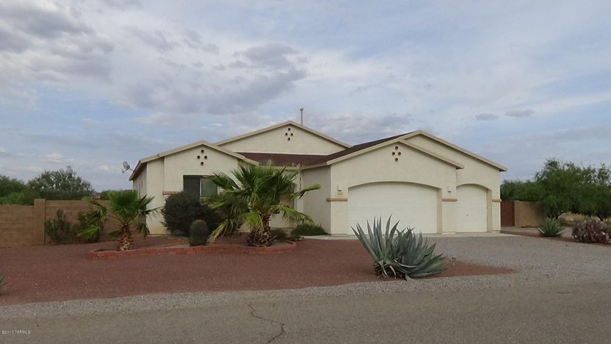 Room to roam and relax. This contemporary home sits on a large, beautiful corner lot in smaller subdivision nestled in quiet Marana countryside. The split floor plan flows easily and features open living spaces at the center of the home. Patio doors open to huge, walled backyard with separate fenced side yard. Kitchen boasts granite tops, large pantry, desk and breakfast bar. Cabinets galore extend into dining area. Great room features gas FP, spacious master suite with generous master bath and walk-in closet. Large laundry room leads to garage. Third garage stall is walled and has electric and wall A/C.